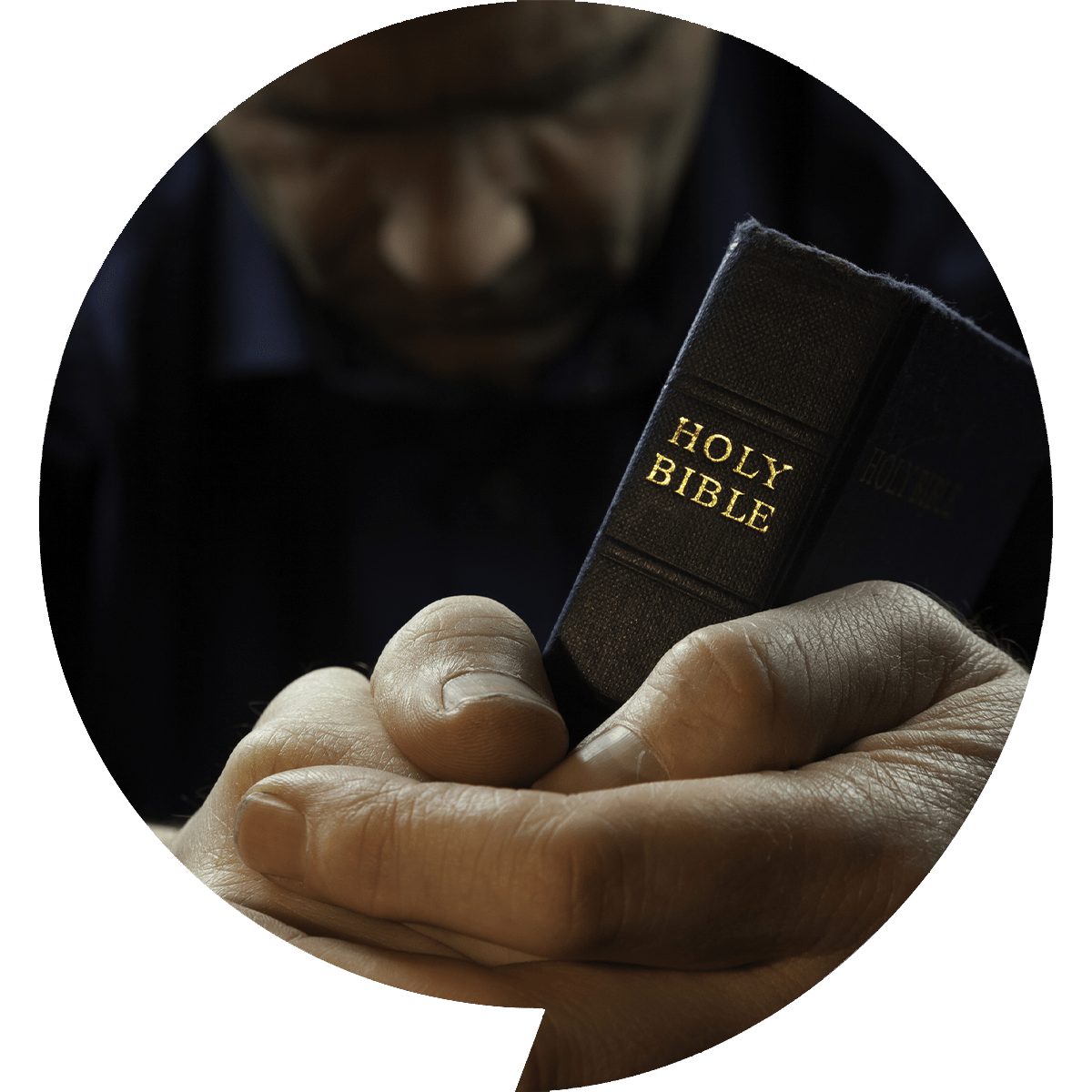 Man Praying Holding A Holy Bible